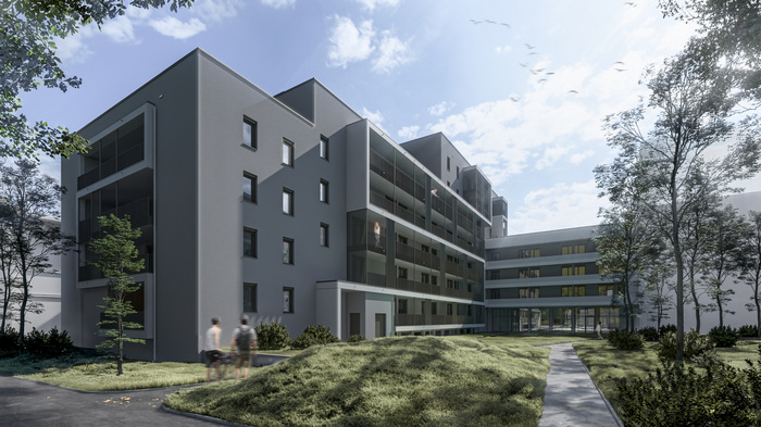 Außenansicht des E-Gebäudes des Studierendenwohnheims der HOK von der Innenhofperspektive. Modernes Gebäude mit Grünanlage.