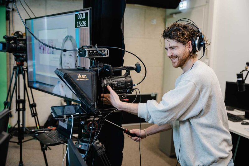 Student arbeitet mit professioneller 4K-Kamera und Teleprompter im Media Lab der HOK an einer Videoaufnahme.